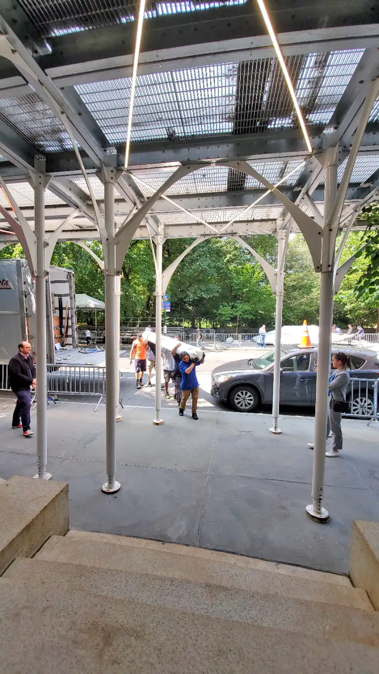 Art handlers holding Mobilier National Savonnerie carpet Les Javels by Julien Gardair on 5th avenue in New York