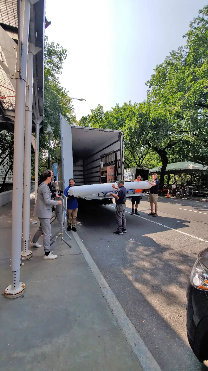 Art handlers holding Mobilier National Savonnerie carpet Les Javels by Julien Gardair on 5th avenue in New York