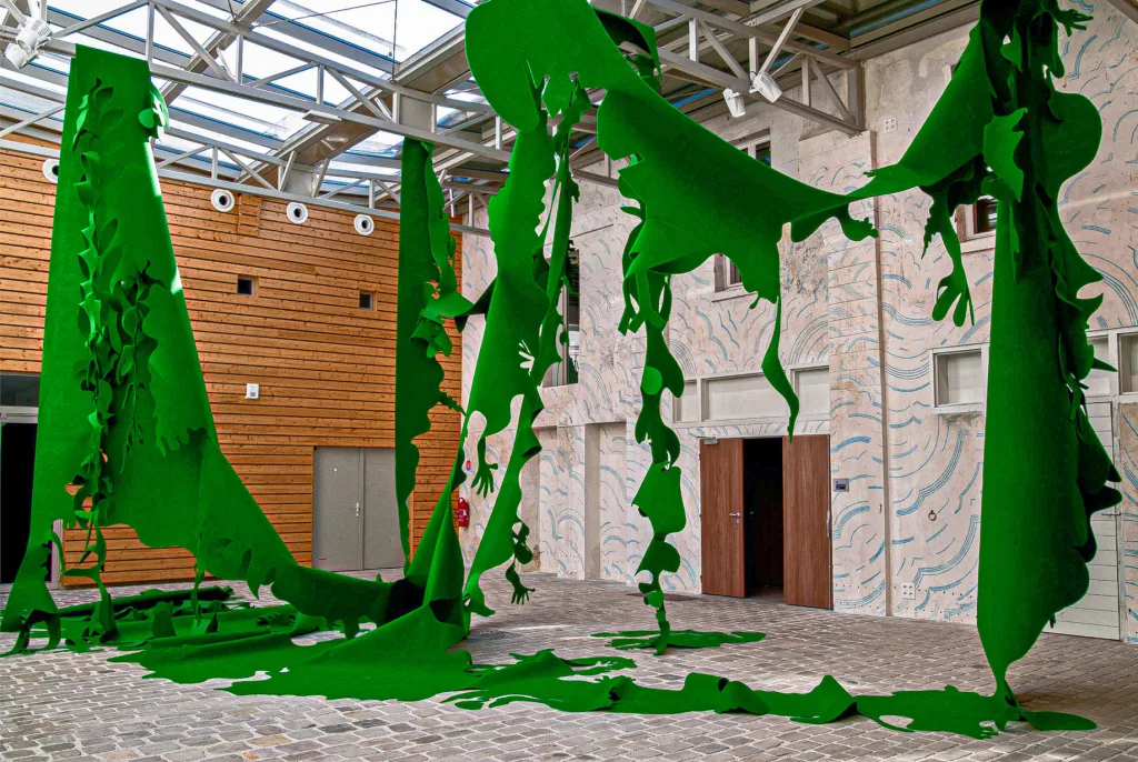 View Grenouille a monumental green felt cutout in space at La Graineterie Art Center in Houilles